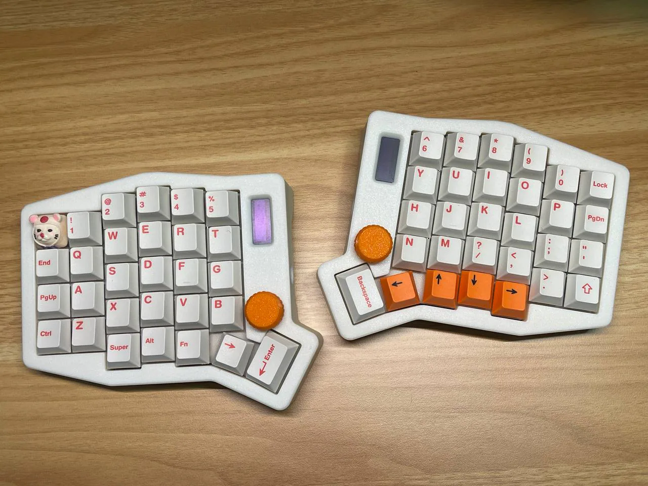White Sofle V2 split keyboard with orange thumb keys